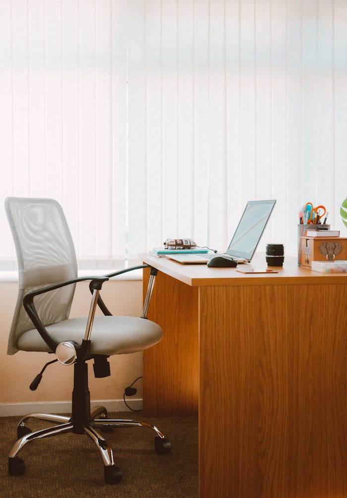 service-01 A tranquil modern home office featuring a wooden desk, ergonomic chair, and soft natural light.