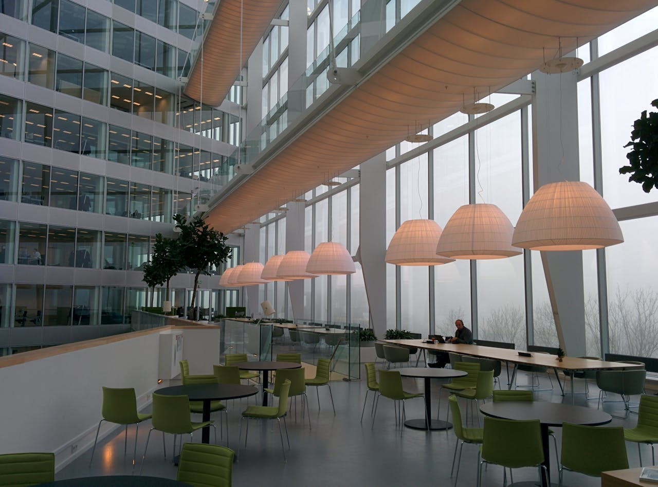 service-03 Contemporary office interior with large windows and stylish furniture, featuring a foggy exterior view.