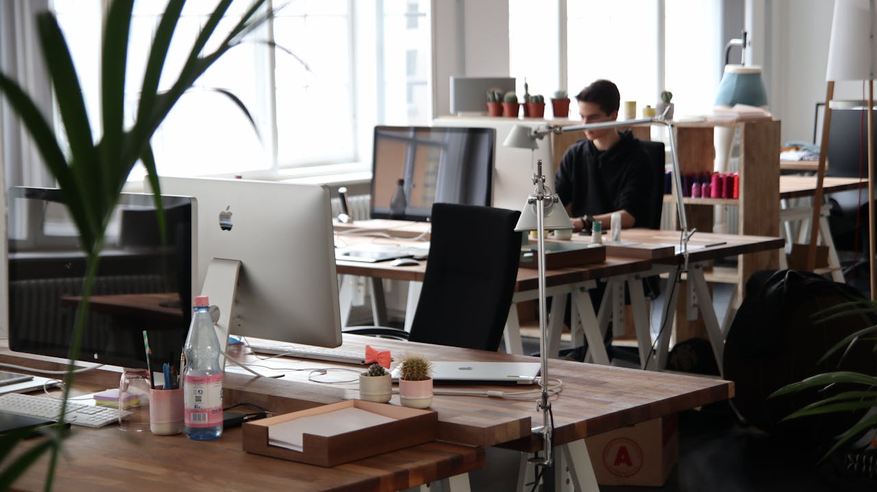 our-stories Open-plan office with modern decor and natural lighting, ideal for productivity.